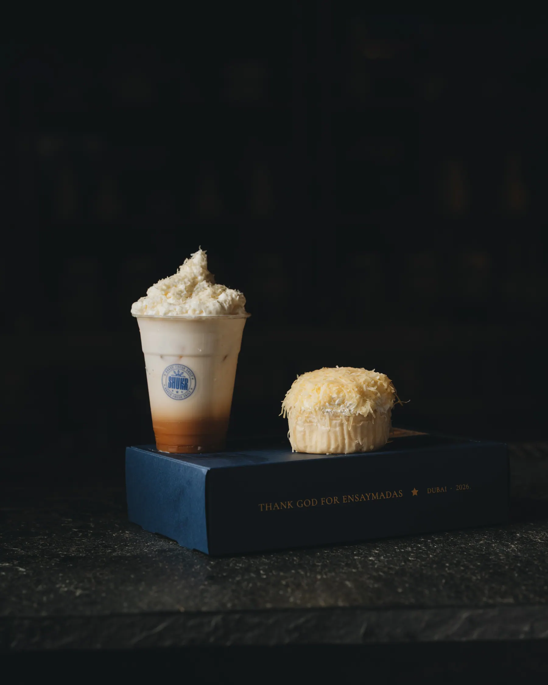 A Coffee Milk Cheese beside an ensaymada