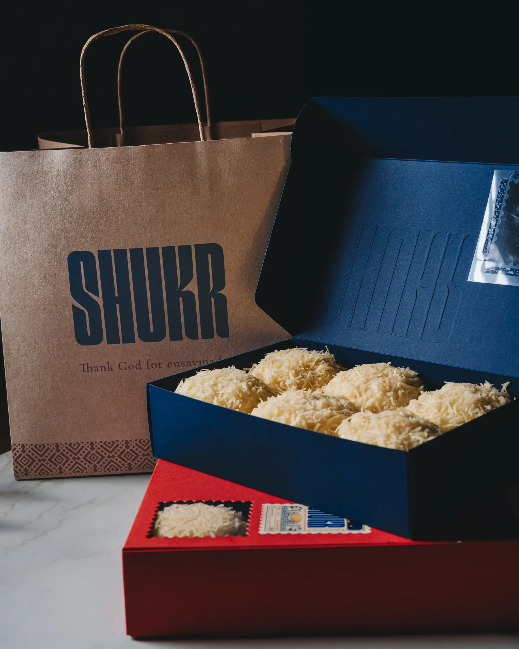The full Shukr kit: carry bag, navy box and red box